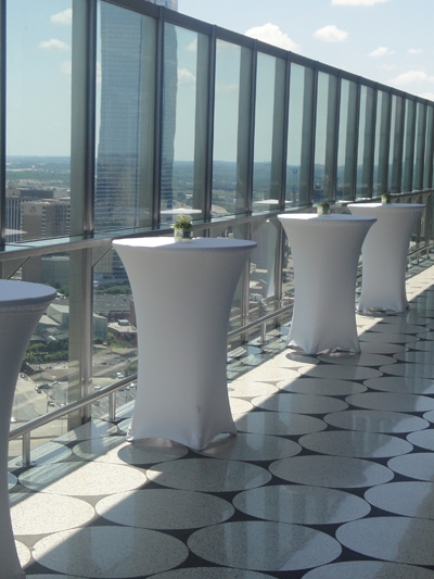 tall cocktail tables with white spandex linens