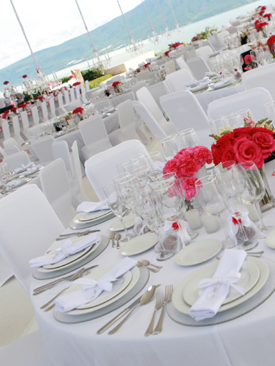 White spandex chair covers used for an outdoor wedding